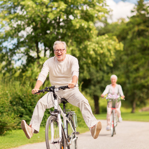 happy old couple on bikes